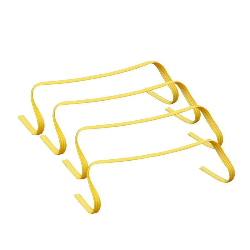 Four yellow plastic mini agility hurdles formed from curved flat strips arranged on a white background.